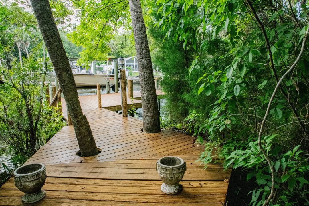 Main dock with boat lift surrounded by trees at Hideout Heights Rental.